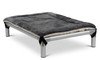 Elevated dog bed with metal frame and black fabric surface